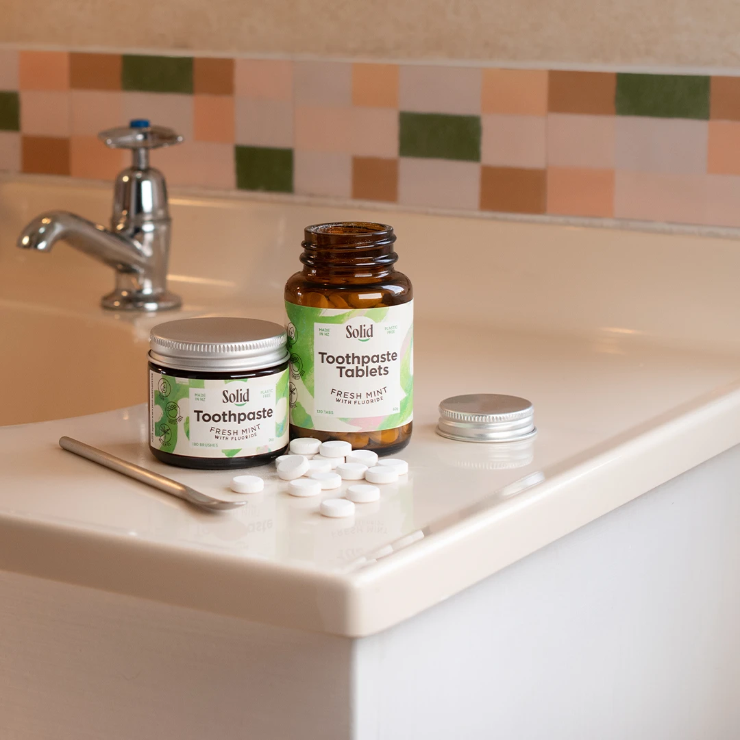 Our Values | Solid Oral Care Toothpaste in a jar and toothpaste tablets on bathroom counter